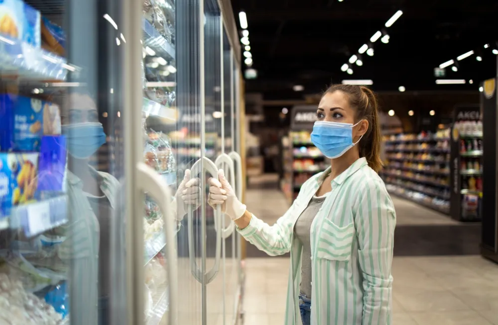 Chiller repair technician inspecting a faulty chiller freezer in a commercial store, offering chiller repair and maintenance services in Dubai.
